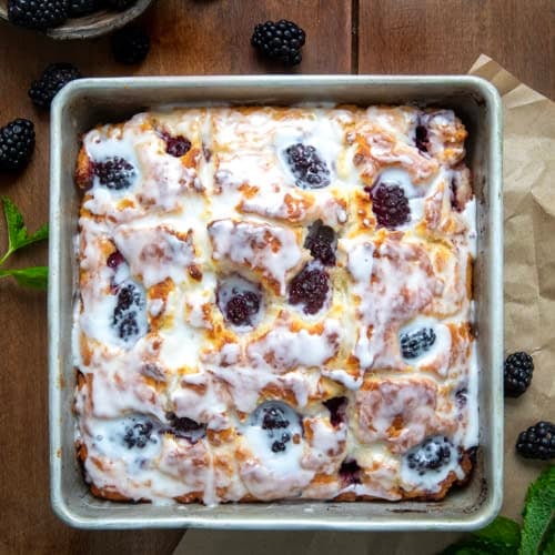 Pan of Blackberry Butter Swim Biscuits on a wooden table from overhead.