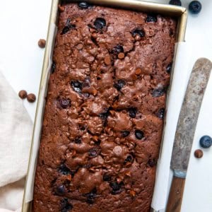 Loaf of Blueberry Brownie Bread on a white table from overhead.