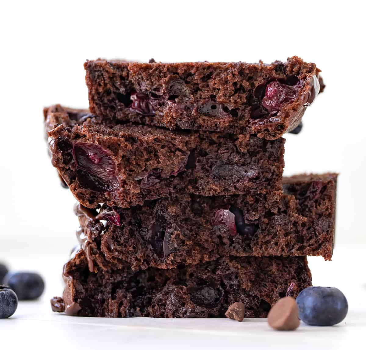 Blueberry Brownie Bread halved with the slices stacked showing tender texture.