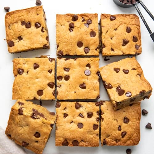 Browned Butter Chocolate Chip Blondies cut into squares on a white table from overhead.