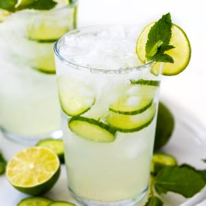 Glasses of Cucumber Mint Refresher on a white platter on a white table.