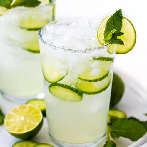 Glasses of Cucumber Mint Refresher on a white platter on a white table.