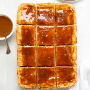 Ooey Gooey Caramel Butter Bars cut into pieces on a white table from overhead.