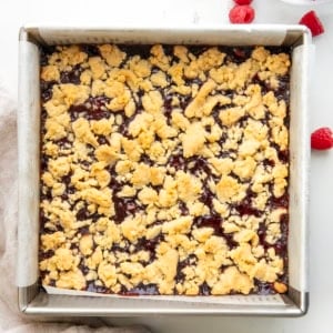 Pan of Raspberry Almond Bars on a white table from overhead.