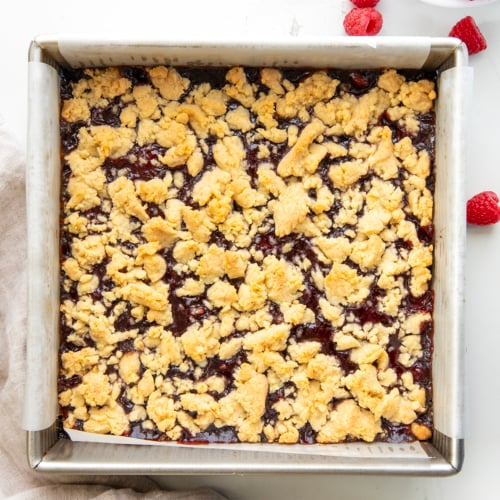 Pan of Raspberry Almond Bars on a white table from overhead.