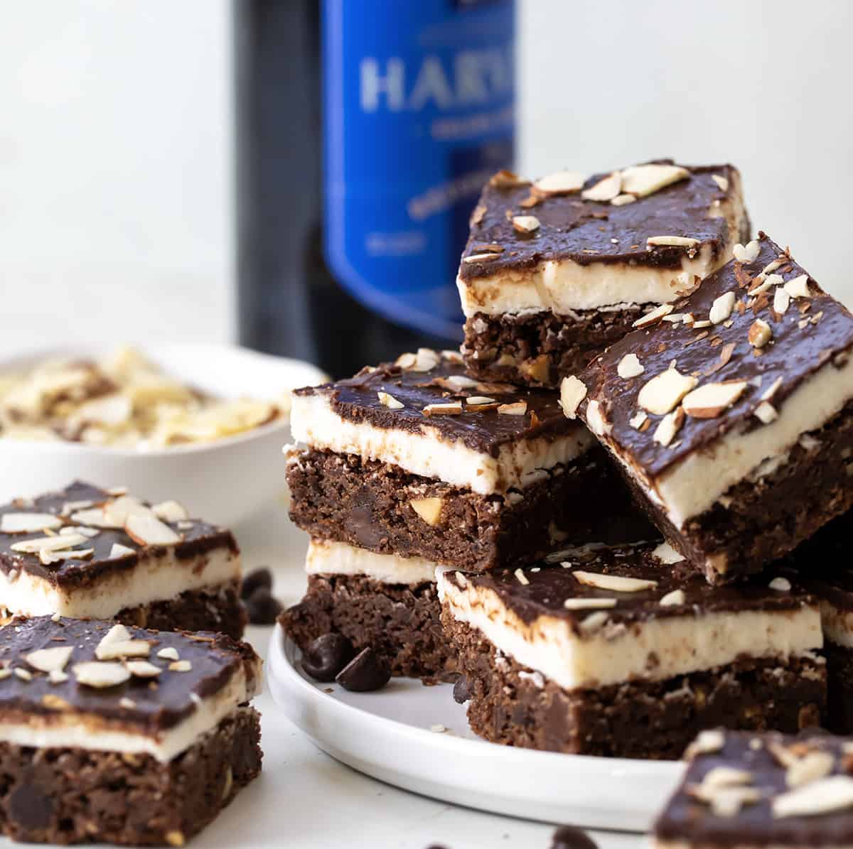 Platter filled with Sherry Almond Brownies and a bottle of sherry in the background.