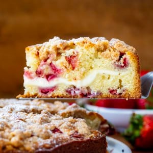Picking up a slice of Strawberries and Cream Coffee Cake from the serving platter.