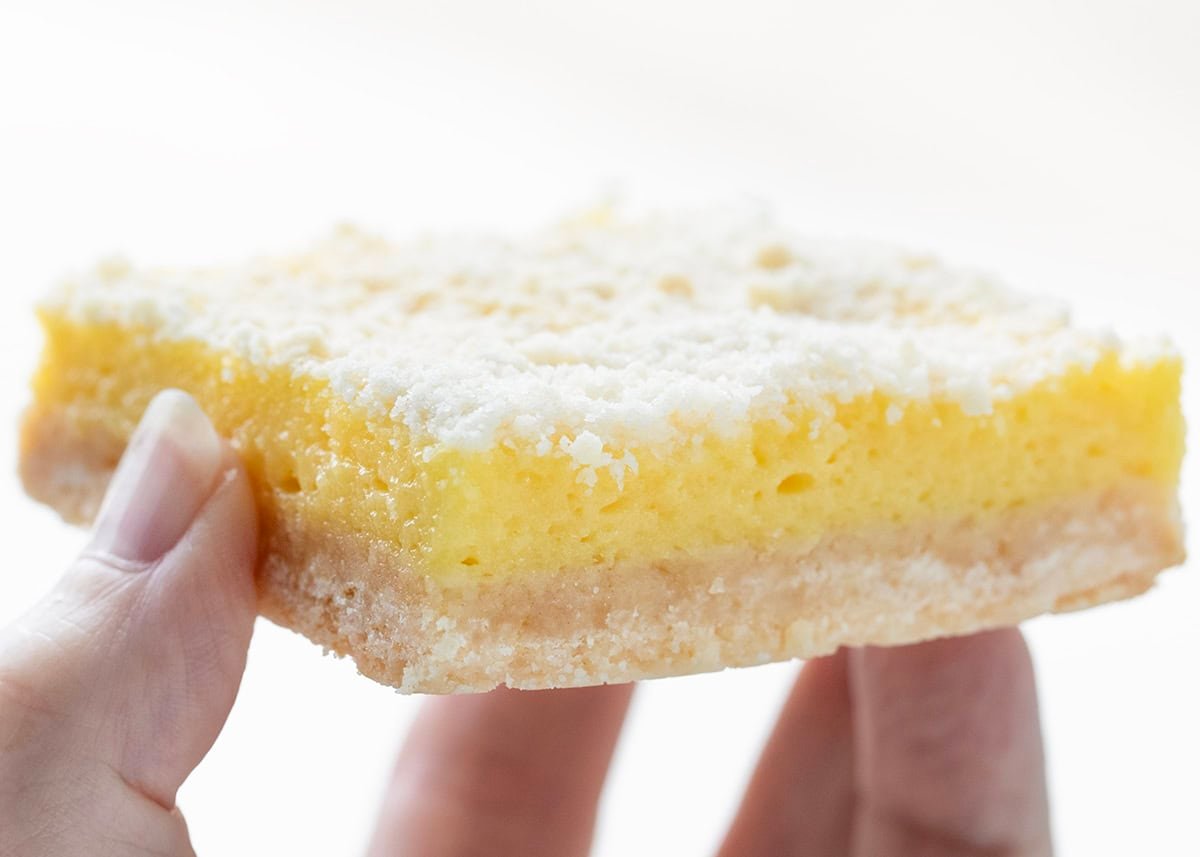 Hand holding Sugar Cookie Lemon Bar.