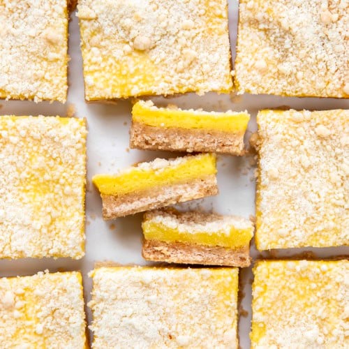 Sugar Cookie Lemon Bars cut into squares with 3 bars on their side.