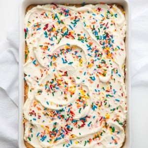 Pan of Birthday Sugar Cookie Bars on a white table from overhead.