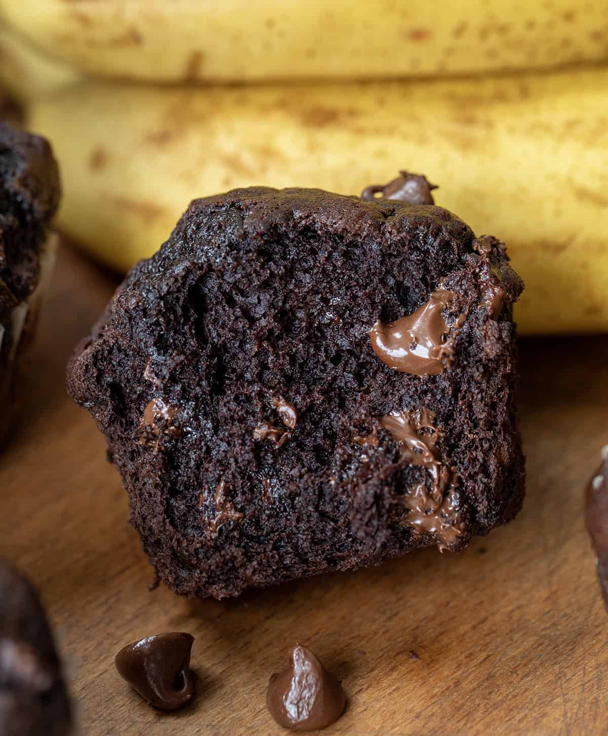 If you are looking for an easy, delicious treat that combines the rich goodness of chocolate with the natural sweetness of ripe bananas, these Double Chocolate Banana Muffins are exactly what you need. (Yes, need!) Broken in half Double Chocolate Banana Muffins showing soft texture inside.