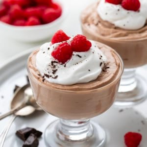 JARS OF Nutella Mousse with fresh raspberries on top.