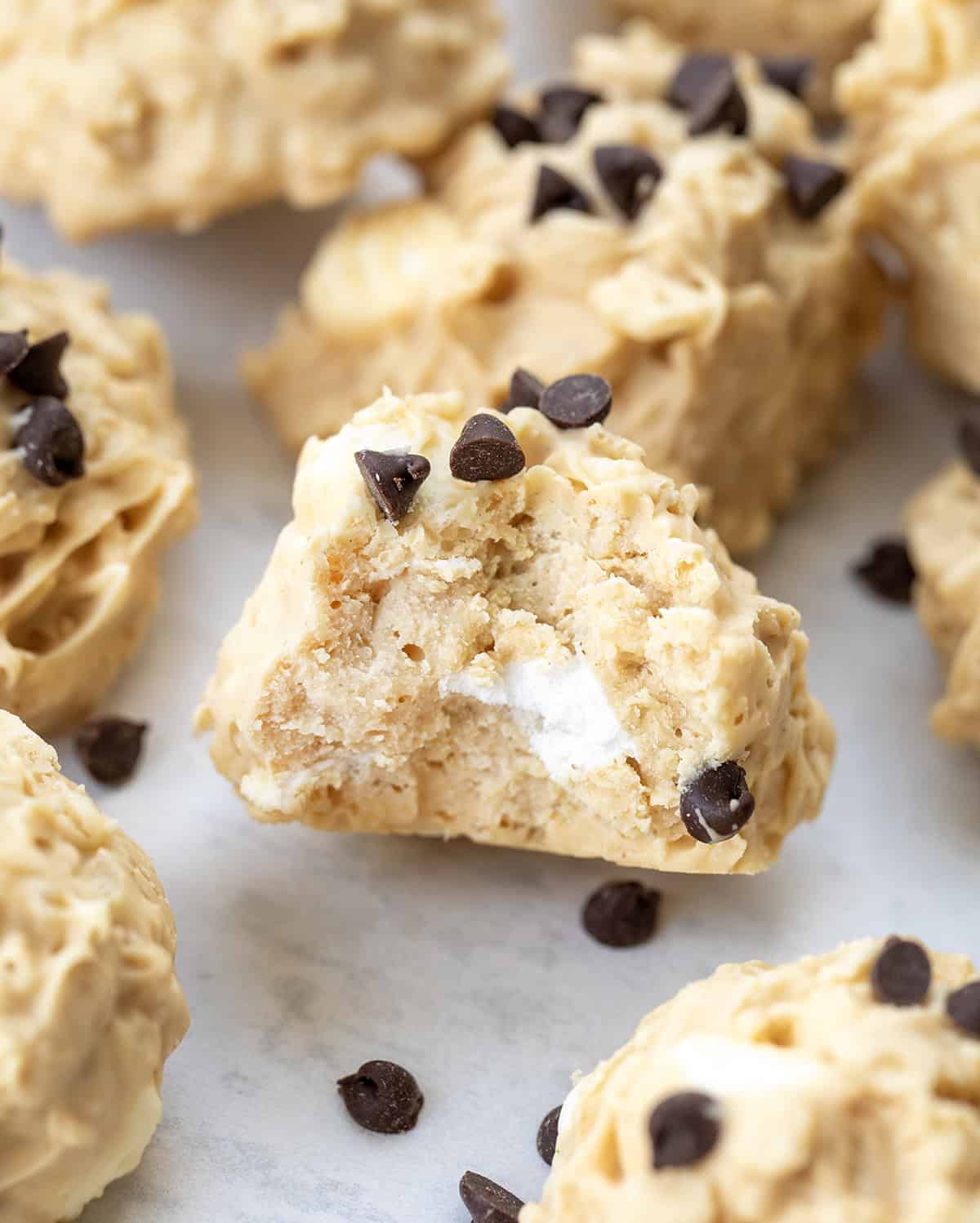 Close up of Avalanche Cookies with a bite taken out of one.