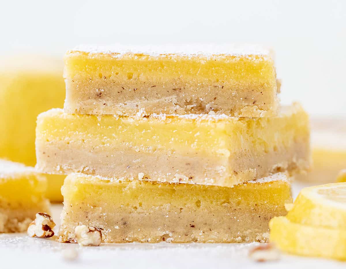 If you have made my (dare I say perfect) Lemon Bars, you already know how bright, tangy, and smooth that lemon filling is. This time, I am changing up the base with a toasted pecan crust. The buttery shortbread takes on a nutty richness, adding extra flavor and a soft crunch that pairs so well with the fresh lemon layer! Stack of Lemon Bars with Pecan Crust very close up.