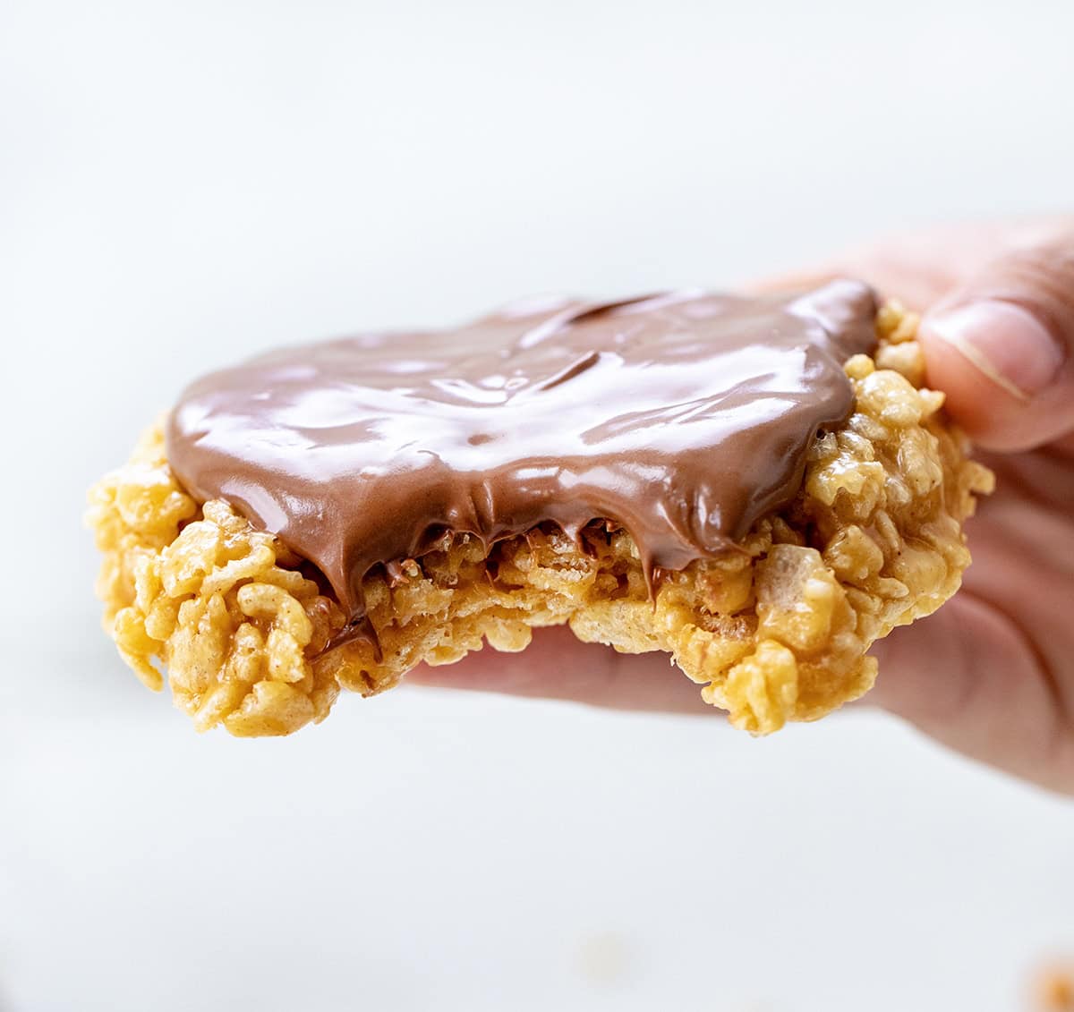 This One-Minute Scotcheroo (made in a mug) is my go-to when I’m craving something sweet and quick, just for me! All the classic Scotcheroo flavor, shaped like a cookie, no oven needed! Hand holding Single-Serving Scotcheroo with a big bite taken out of it.
