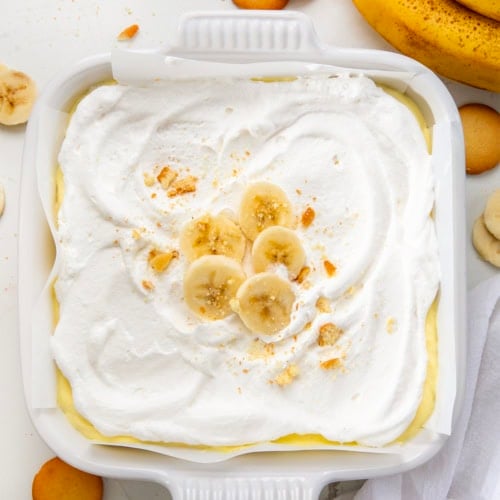 Pan of Banana Cream Pie Bars on a white table from overhead.