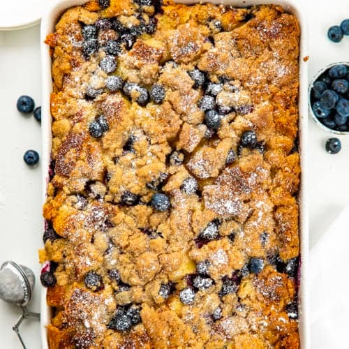 Blueberry Lemon French Toast Bake in a white casserole plan on a white table from overhead.