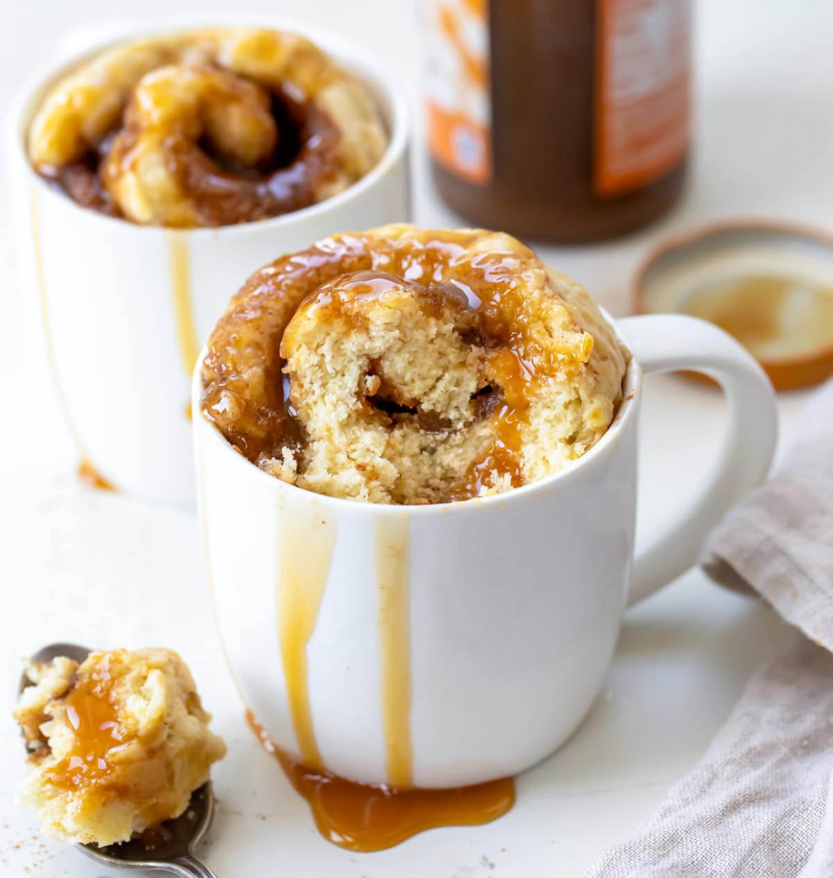Caramel Roll in a Mug with a portion removed to show texture.
