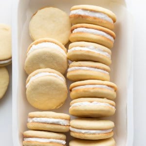 Small white platter of Golden Oreo Cookies on a white table from overhead.