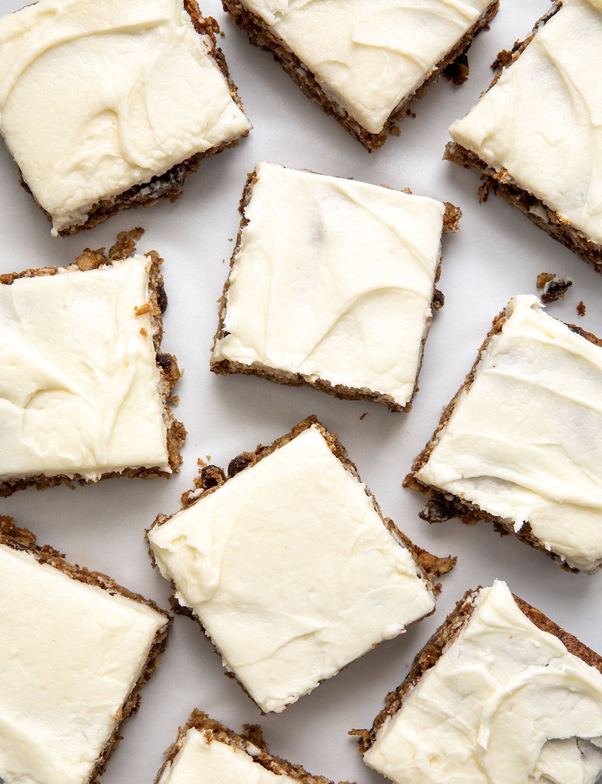 Oatmeal Raisin Cookie Bars cut into squares on a white table from overhead.