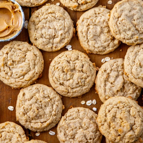 Peanut Butter Oatmeal Cookies on a wooden table all spread out from overhead.