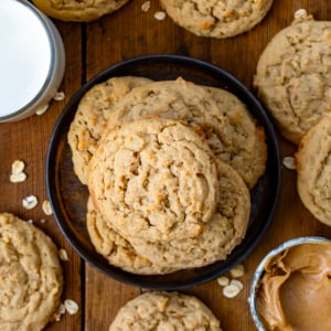 Peanut Butter Oatmeal Cookies on a small black plate on a wooden table from overhead.