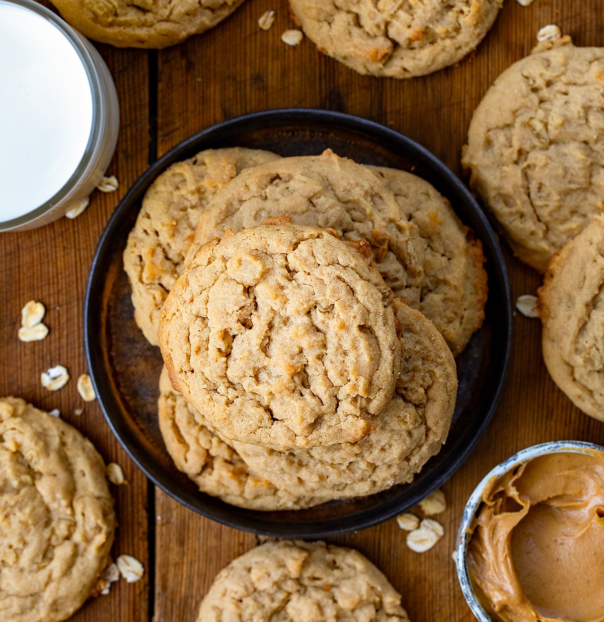 Peanut Butter Oatmeal Cookies on a small black plate on a wooden table from overhead.