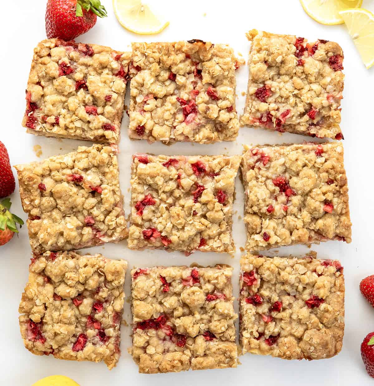 Strawberry Lemon Crumb Bars cut into squares on a white table from overhead.