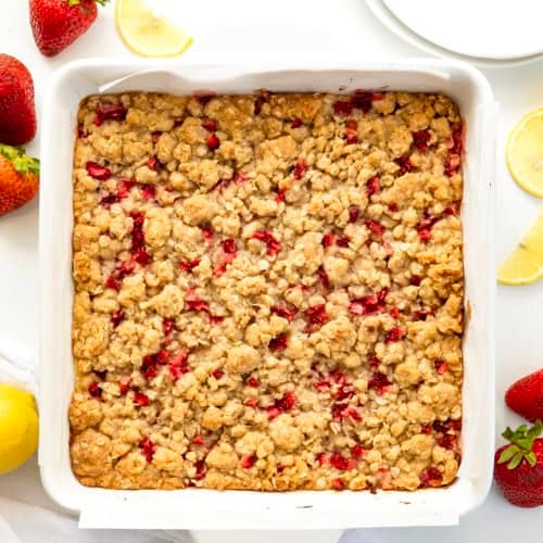 White pan filled with fresh Strawberry Lemon Crumb Bars on a white table from overhead.
