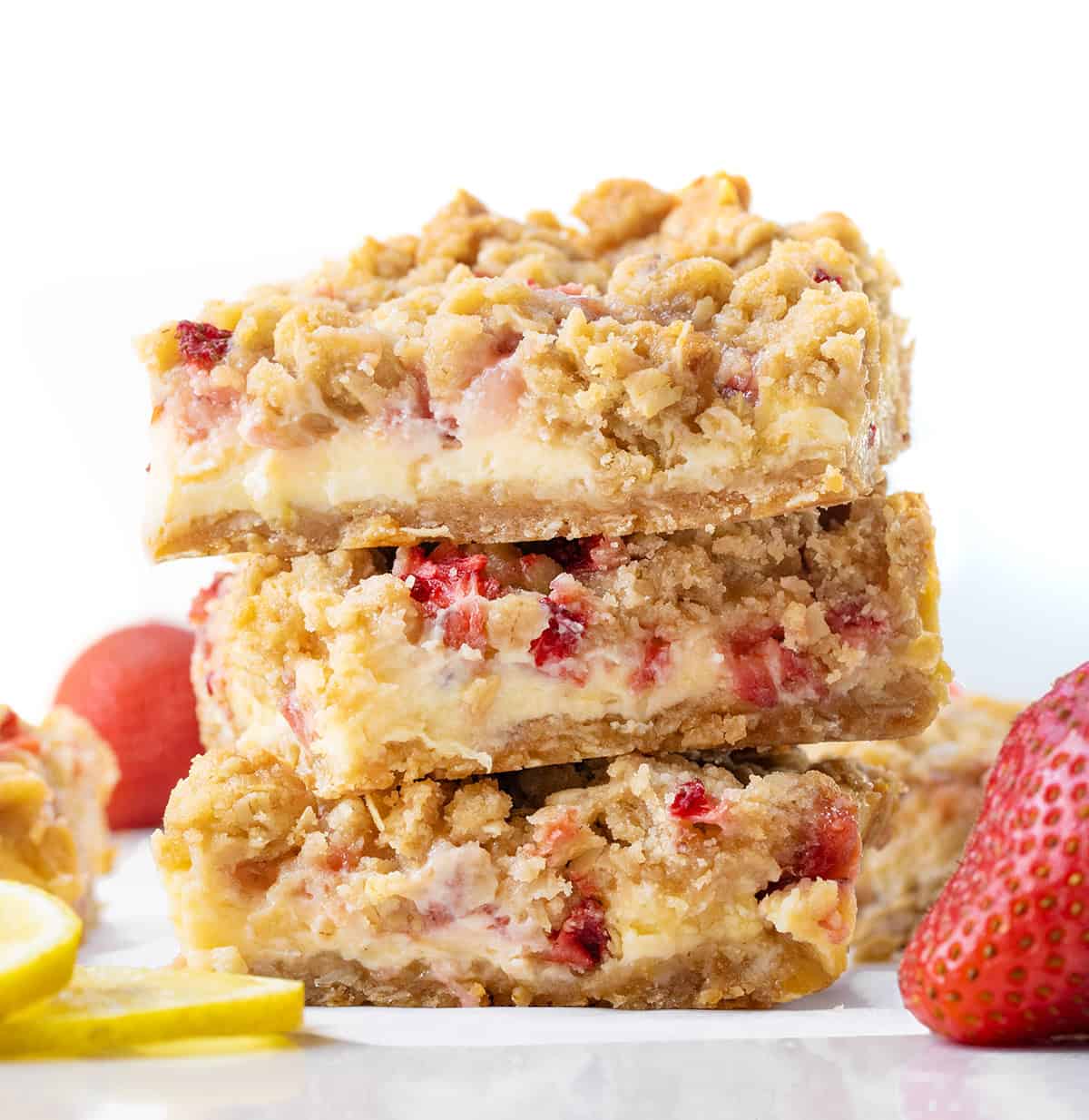 Stack of Strawberry Lemon Crumb Bars on a white table.
