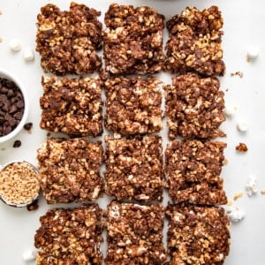 Toffee Crunch Popcorn Bars cut into squares on a white table from overhead.