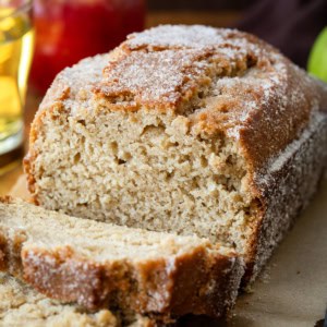 Close up of Apple Cider Donut Bread that has been cut into with pieces falling.