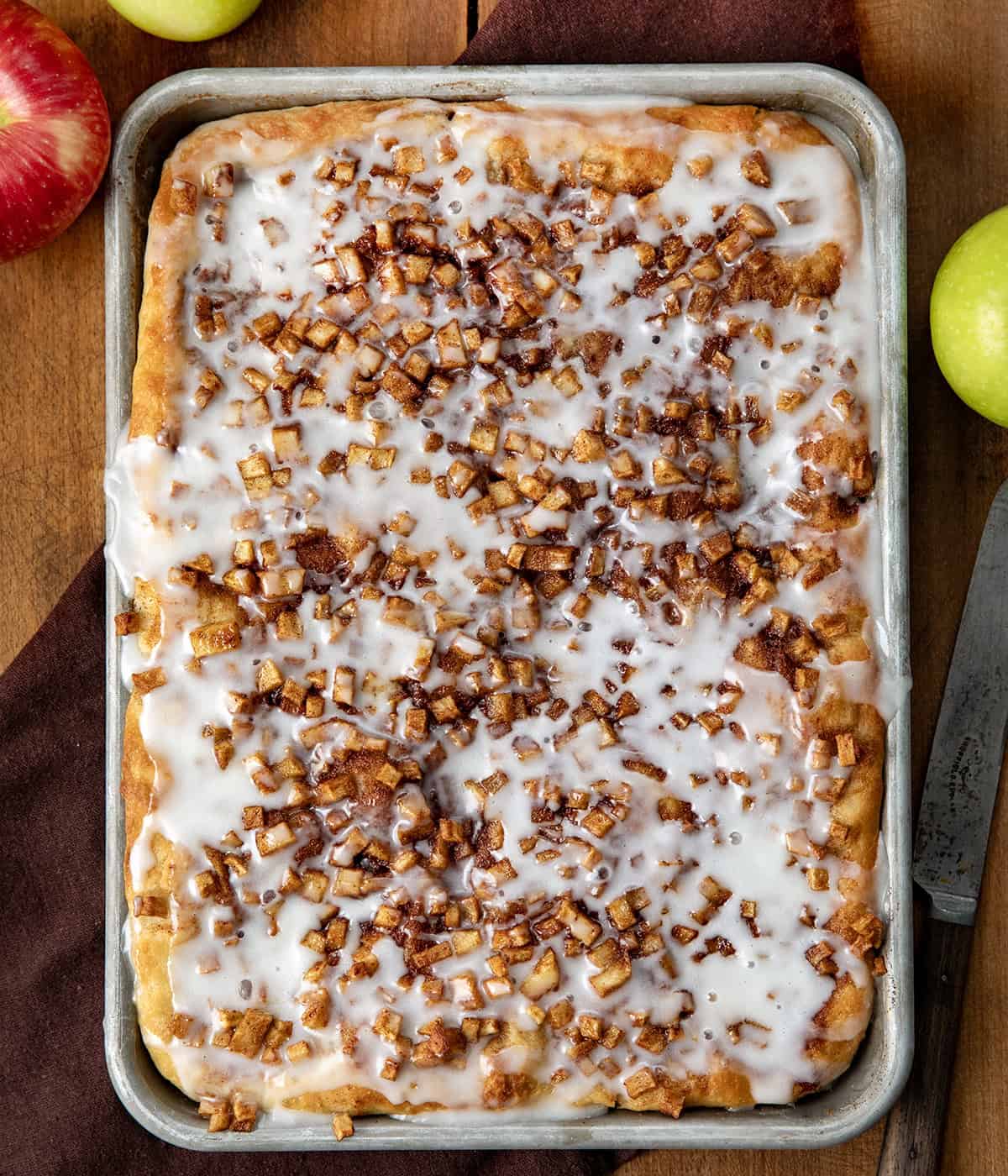 Pan of Apple Fritter Focaccia on a wooden table from overhead.