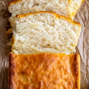 Loaf of Butter Swim Bread with some pieces cut and fallen on the table from overhead.
