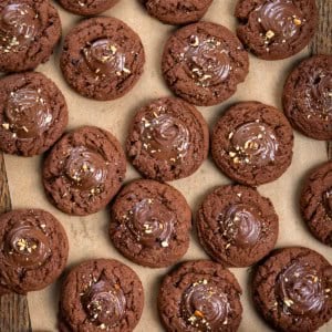 Chocolate Hazelnut Thumbprint Cookies on a wooden table from overhead.