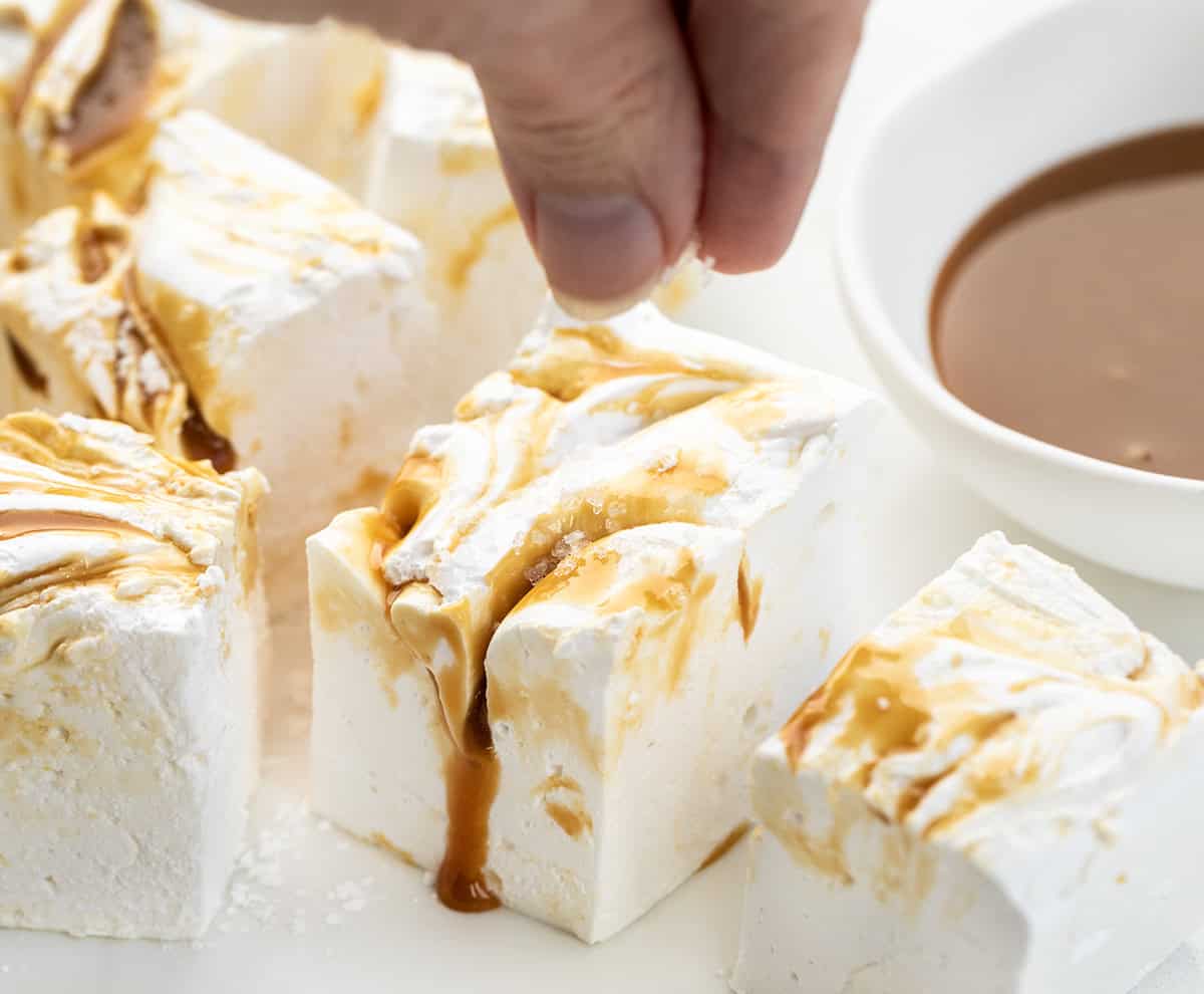 Sprinkling sea salt over Caramel Swirl Marshmallows.