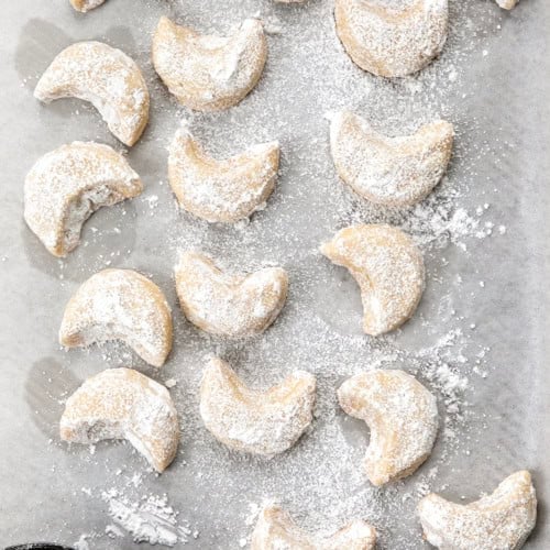 Almond Crescent Cookies on a sheet pan.