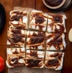 Apple Butter Cheesecake Bars cut into squares on a wooden table from overhead.