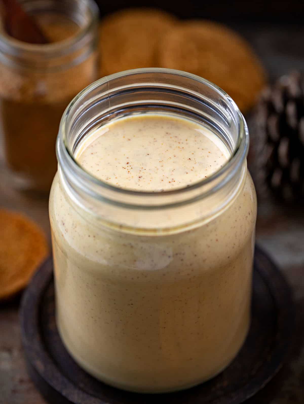 Bring the cozy flavors of the season to your morning coffee with this Homemade Gingerbread Creamer! Rich, creamy, and perfectly spiced with notes of cinnamon, ginger, and nutmeg, it’s a simple way to upgrade your coffee or latte at home with no specialty store trips required! Mason jar filled with Gingerbread Creamer on a wooden table.