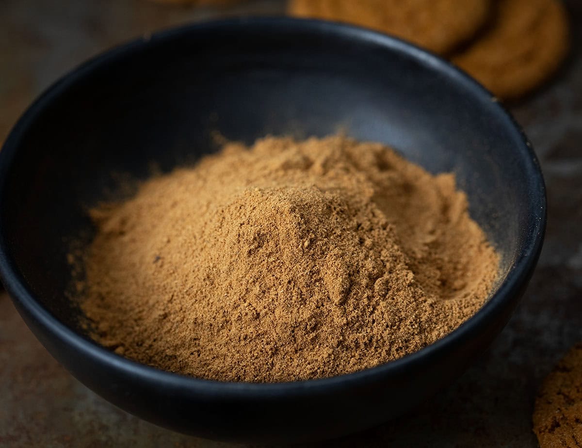 Warm up your winter baking with my special Gingerbread Spice Mix! A cozy, homemade blend that instantly makes your kitchen smell like the holidays. This easy mix captures all the nostalgic flavor of classic gingerbread in one jar! Bowl of Gingerbread Spice Mix on a wooden table.