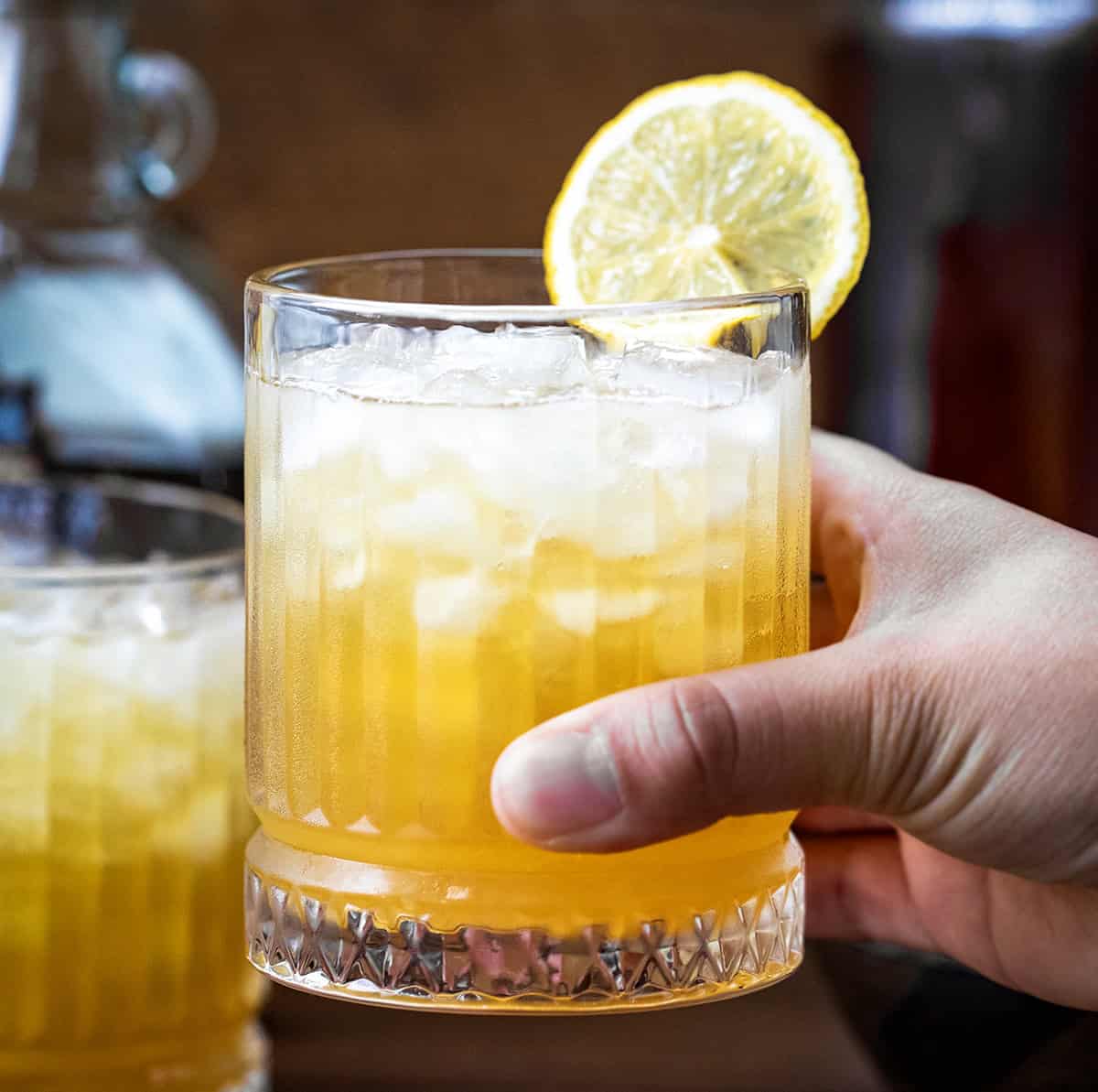 Hand holding a Maple Whiskey Sour.
