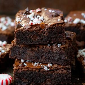 Stack of Peppermint Brownies with more brownies around it.