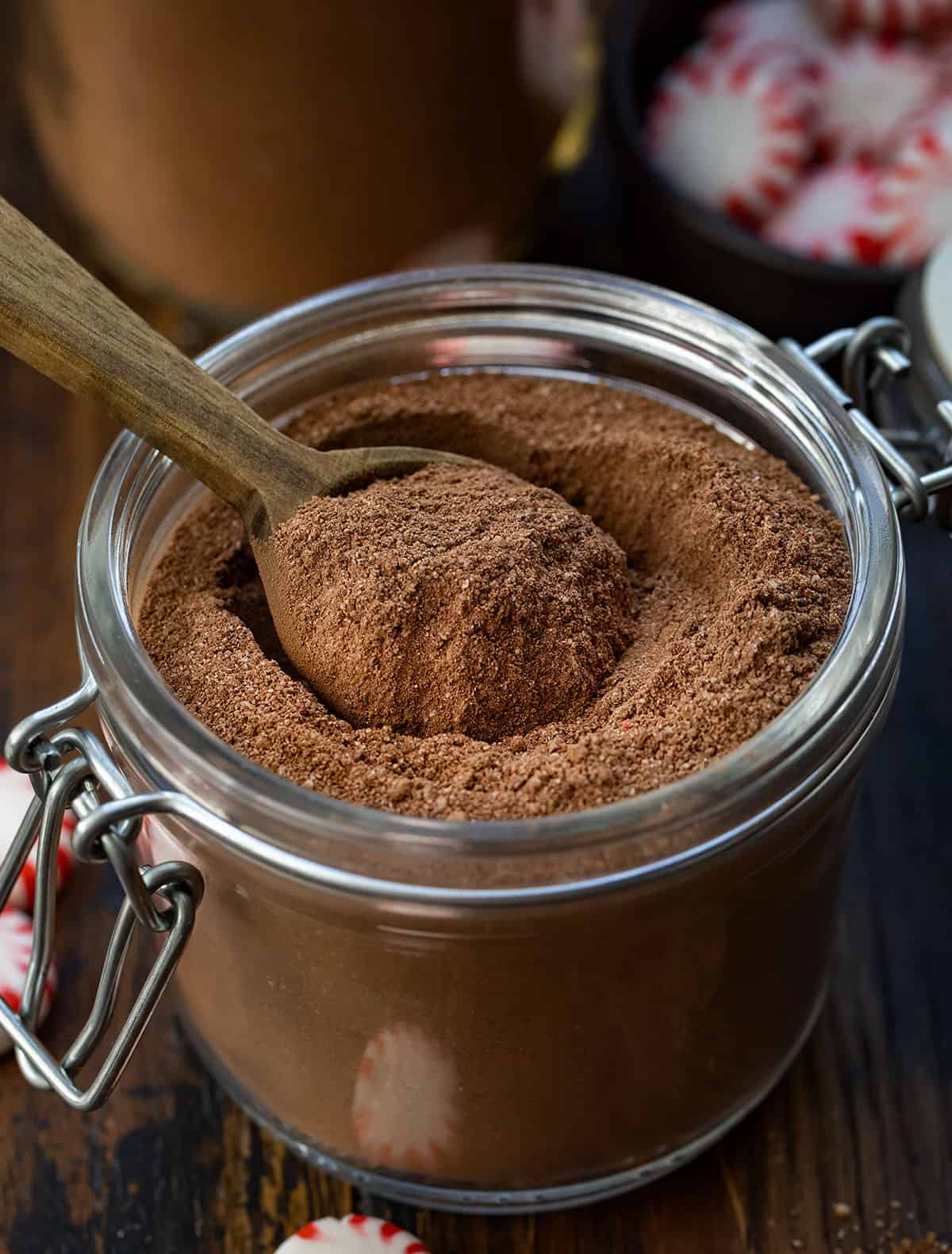 Nothing says cozy winter nights like a mug of rich, creamy hot chocolate with a hint of peppermint. This Peppermint Hot Cocoa Mix is easy to make ahead, customizable, and perfect for gifting during the holidays. Each sip delivers a smooth chocolate flavor with a refreshing minty finish! Jar of Peppermint Hot Cocoa Mix with a measuring spoon in the container.