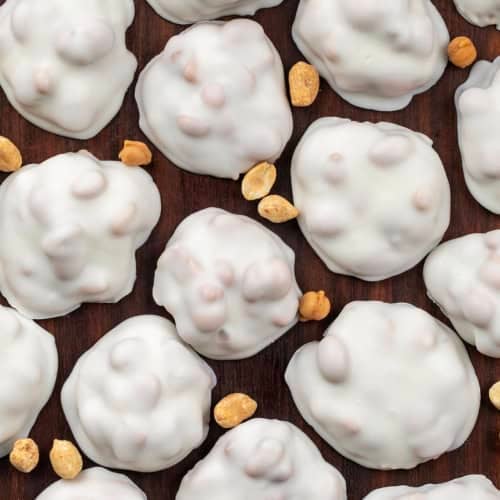 Polar Bear Paws spread out on a wooden table with peanuts from overhead.