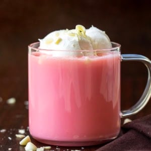 Glass of Strawberry Hot Chocolate on a wooden table.