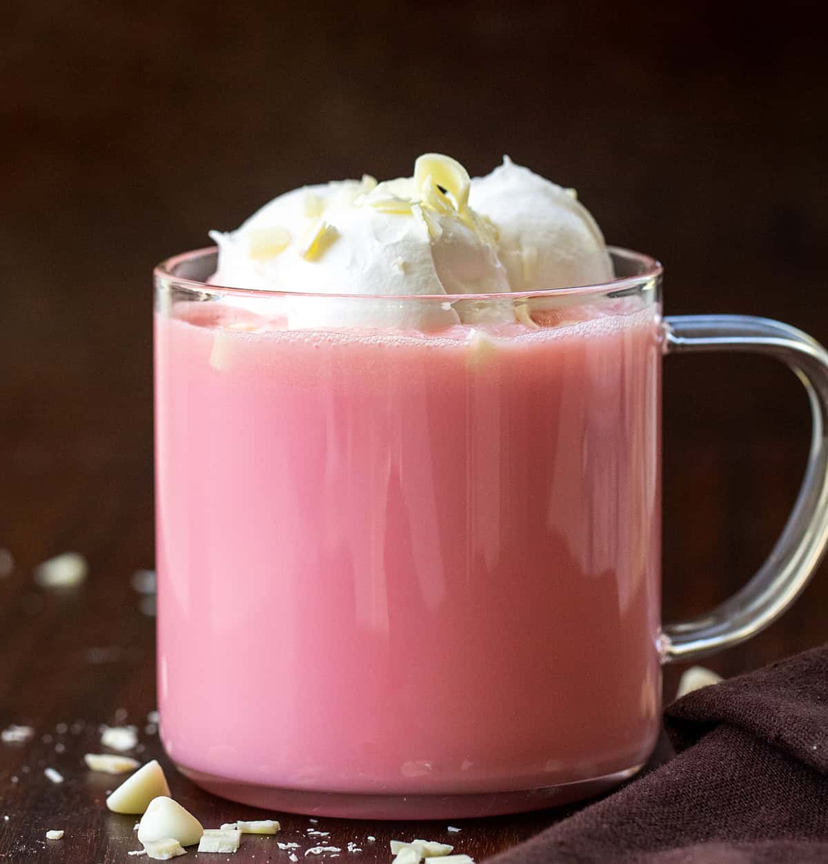 Glass of Strawberry Hot Chocolate on a wooden table.