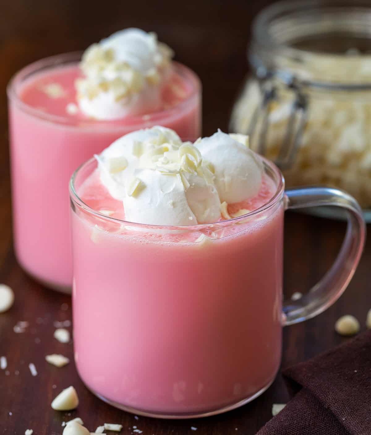 Glasses of Strawberry Hot Chocolate on a wooden table.