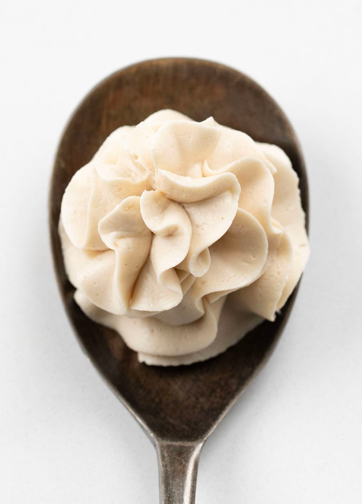 Spoon with a bit of Brown Sugar Ermine Frosting piped onto it.