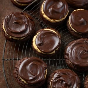 Buckeye Cookies on a cooling rack on a dark table.