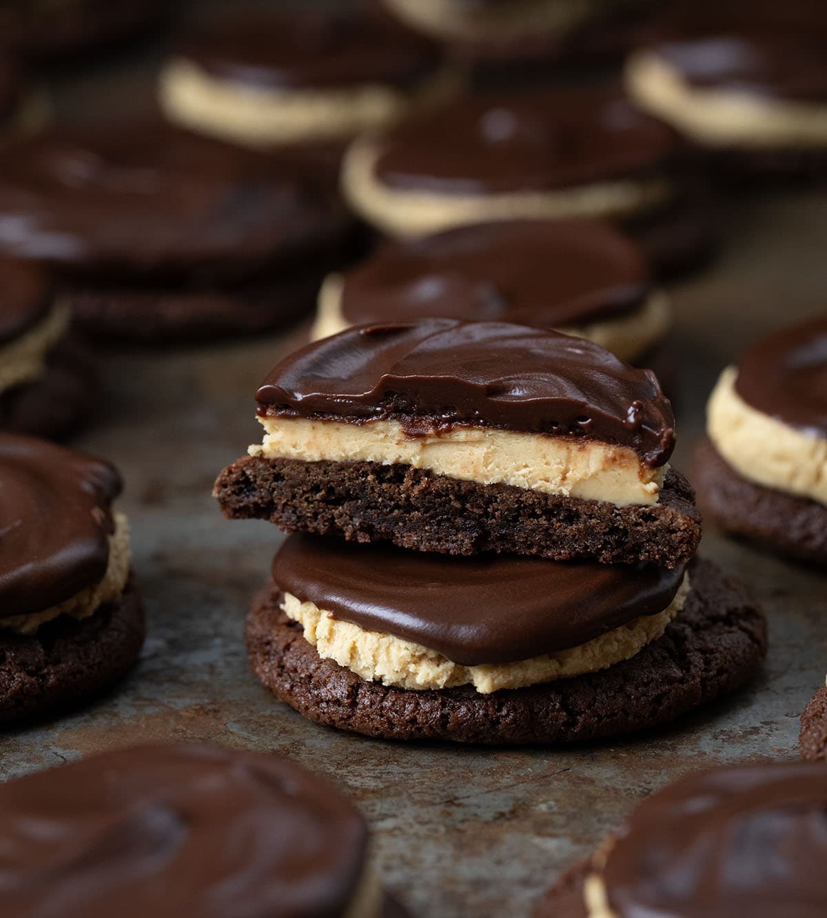 Buckeye Cookies stacked and one cut in half showing layers.